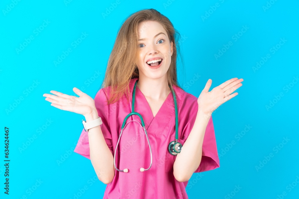 Young caucasian doctor woman wearing pink medical uniform celebrating crazy and amazed for success with arms raised and open eyes screaming excited. Winner concept Young caucasian doctor woman wearing pink medical uniform celebrating crazy and amazed for success with arms raised and open eyes screaming excited. Winner concept