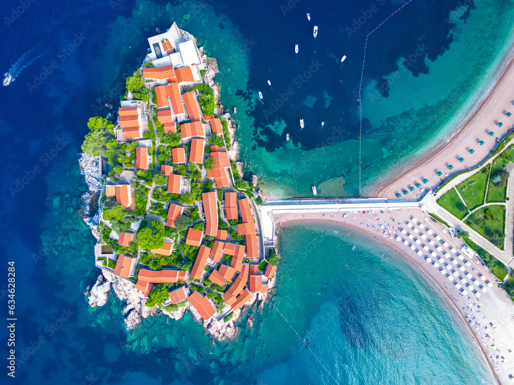 Island of Sveti Stefan near Budva in Montenegro. Beaches and coastline of the Adriatic Sea at summer time. Natural landscapes of Montenegro. Balkans. Europe.