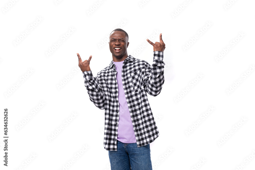 Naklejka premium handsome young american man in a plaid shirt is actively moving