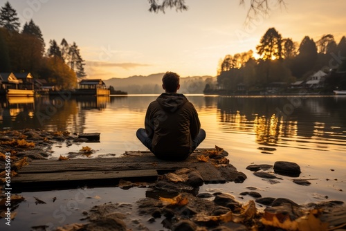 Person sitting alone on a quiet dock - stock photography concepts
