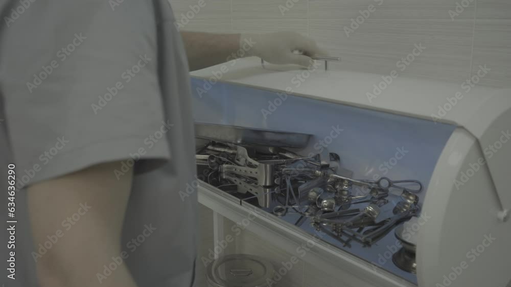 Medical instrument chamber. Operating room. Instruments for surgeries. Modern medicine. Employee opens the instrument chamber Medical instrument chamber. Operating room. Instruments for surgeries. Modern medicine. Employee opens the instrument chamber