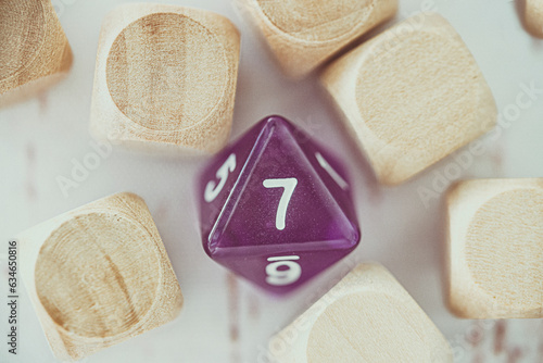 Close-up of an 8 sided dice amongst blank wooden cubes