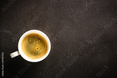 Coffee cup. espresso in white cup at dark table. Top view image.