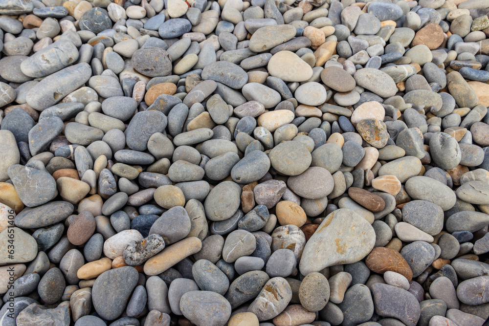 Smooth round pebbles texture background. Pebble sea beach close-up Smooth round pebbles texture background. Pebble sea beach close-up