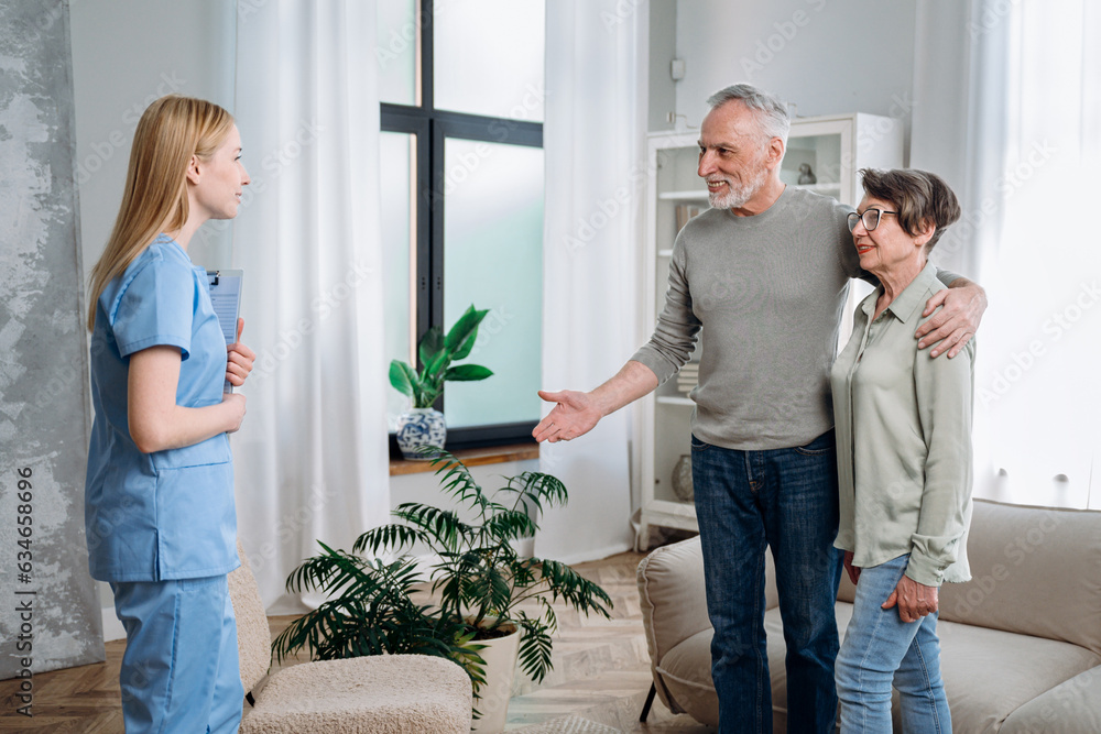 Happy elderly couple meeting medical nurse at home Happy elderly couple meeting medical nurse at home