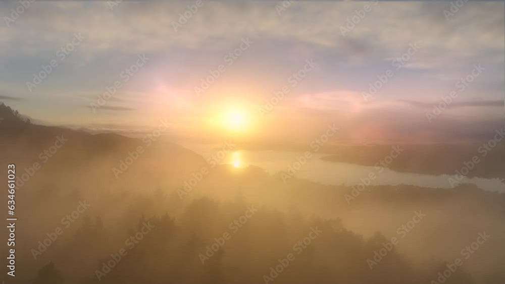 Aerial shot of beautiful, coloured, sunset with heavy clouds and misty sun in winter time, camera moving into amazing landscape of sunset at sea Aerial shot of beautiful, coloured, sunset with heavy clouds and misty sun in winter time, camera moving into amazing landscape of sunset at sea