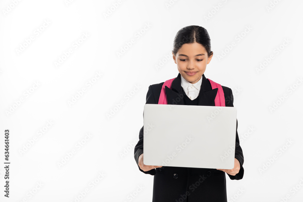 smiling schoolgirl using laptop isolated on white, e-study, student in uniform isolated on white smiling schoolgirl using laptop isolated on white, e-study, student in uniform isolated on white
