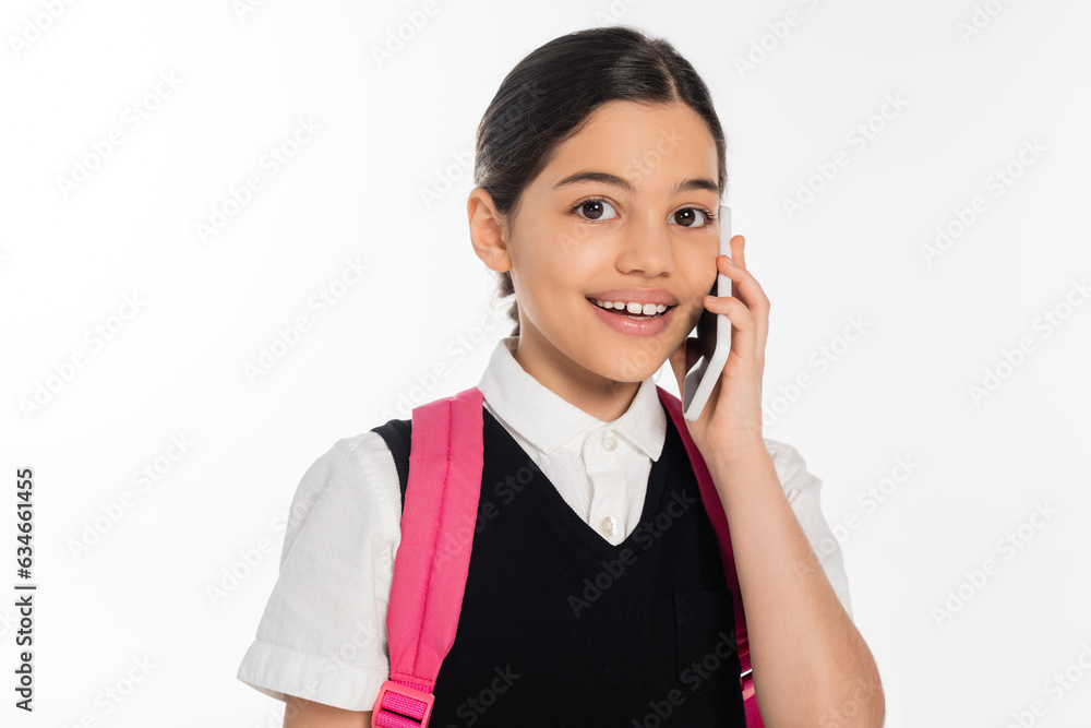 digital age, positive schoolgirl with backpack talking on smartphone isolated on white, student life digital age, positive schoolgirl with backpack talking on smartphone isolated on white, student life