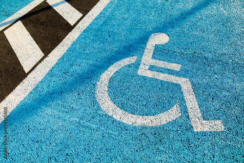 Parking space painted in blue, reserved for people with reduced mobility, or disabled people, who use wheelchairs, Spain photo