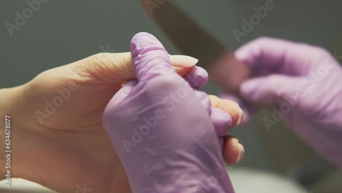  Close up video of master making nails in salon. photo