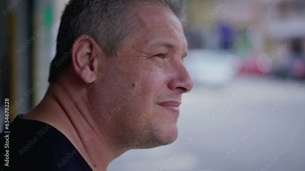 Man standing in street observing urban neighborhood. 40s middle aged male person looking at sidewalk in front of storefront Man standing in street observing urban neighborhood. 40s middle aged male person looking at sidewalk in front of storefront