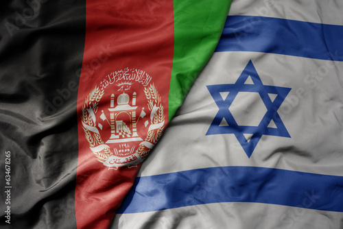 big waving realistic national colorful flag of afghanistan and national flag of israel .
