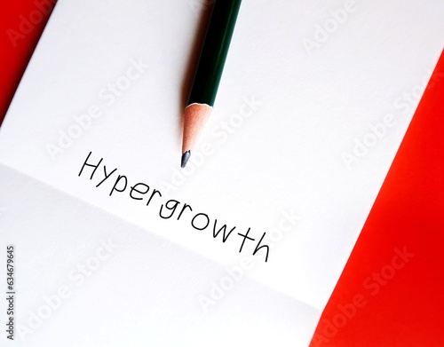 Pencil wrote on notebook a buzzword  - Hypergrowth - means steep part of the S-curve that young industries experience that sets them from losers or rapid, high speed, exponential growth of business photo