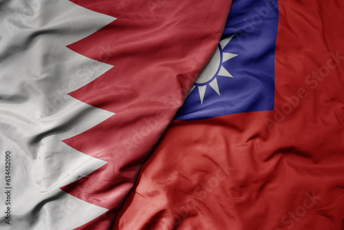 big waving realistic national colorful flag of bahrain and national flag of taiwan .
