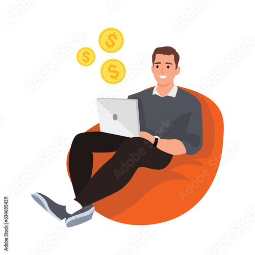 Happy man working on a laptop computer while sitting in a bean bag chair over isolated background. Freelancer guy working at home.