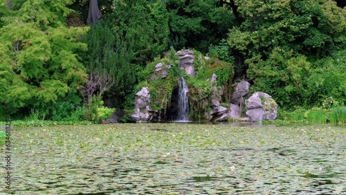 Water Lily (Nympheas) Pond and Cascade in the Bagatelle Park. The Park is located in Boulogne-Billancourt near Paris, France