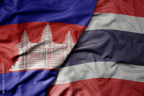 big waving realistic national colorful flag of cambodia and national flag of thailand .