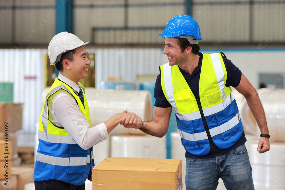 Group of technician engineer in protective uniform with hardhat standing and shaking hands celebrate successful together or completed deal commitment at industry warehouse manufacturing factory Group of technician engineer in protective uniform with hardhat standing and shaking hands celebrate successful together or completed deal commitment at industry warehouse manufacturing factory
