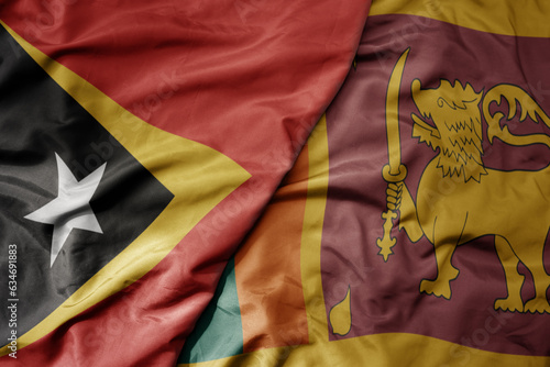 big waving realistic national colorful flag of east timor and national flag of sri lanka .