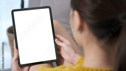 Woman hand using digital tablet with blank screen for mock up, template