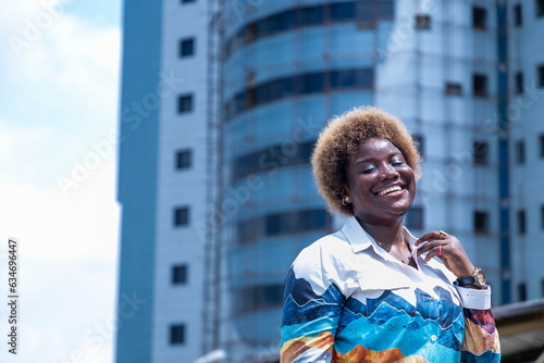 African woman standing in front of a tall building
