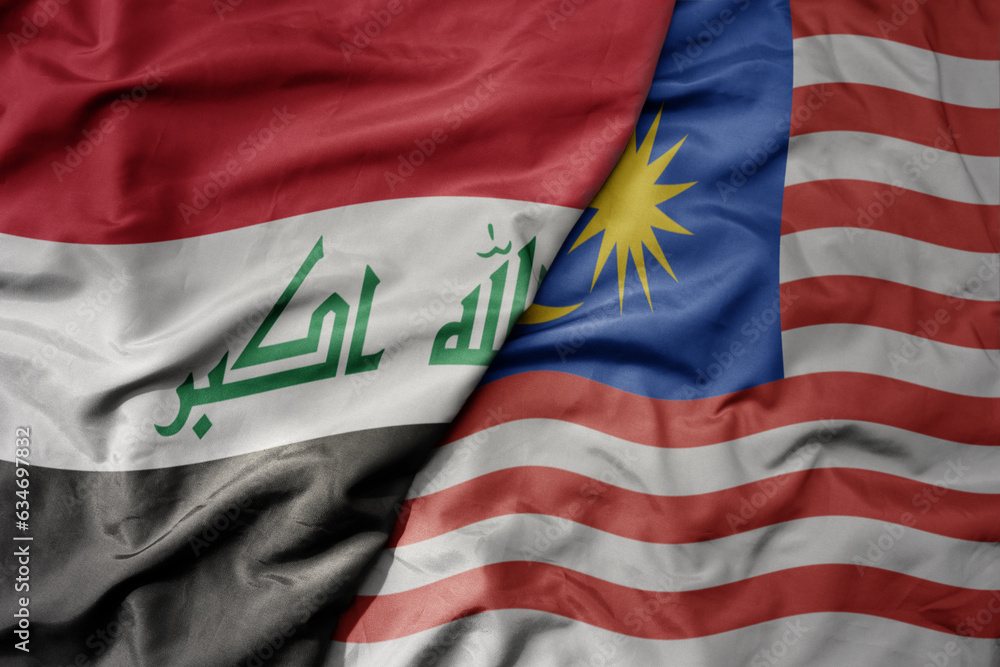 Fototapeta premium big waving realistic national colorful flag of iraq and national flag of malaysia .