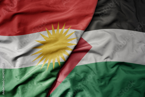 Bild auf Leinwand big waving realistic national colorful flag of kurdistan and national flag of palestine