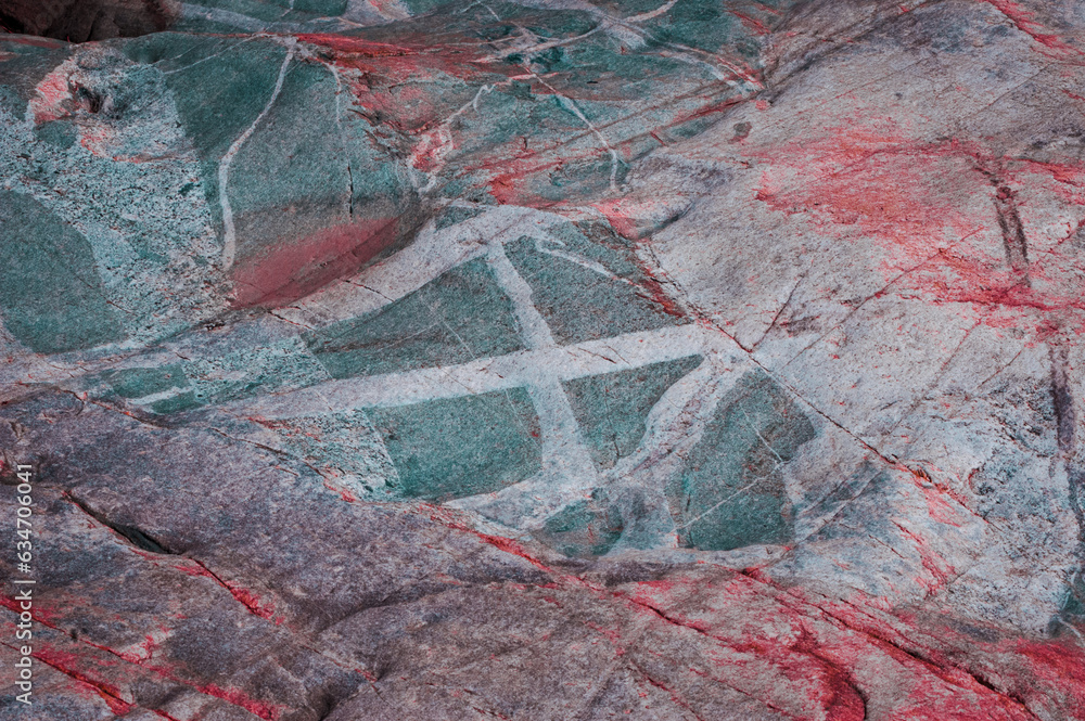 Bright red and white patterns on a rock surface