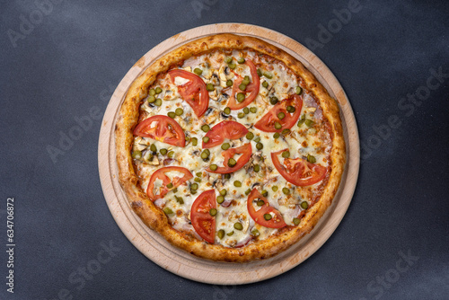 Italian cuisine. Delicious pizza on a dark background