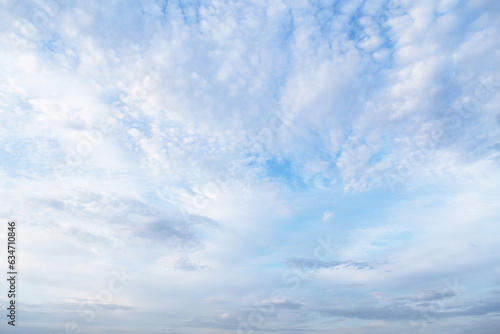 Beautiful epic soft gentle blue sky with white and grey cirrus and fluffy clouds background texture