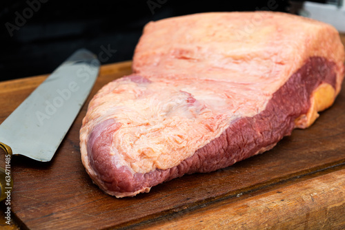 ponta de peito or brisket, raw for barbecue over wooden table photo