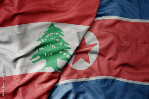 big waving realistic national colorful flag of lebanon and national flag of north korea . photo