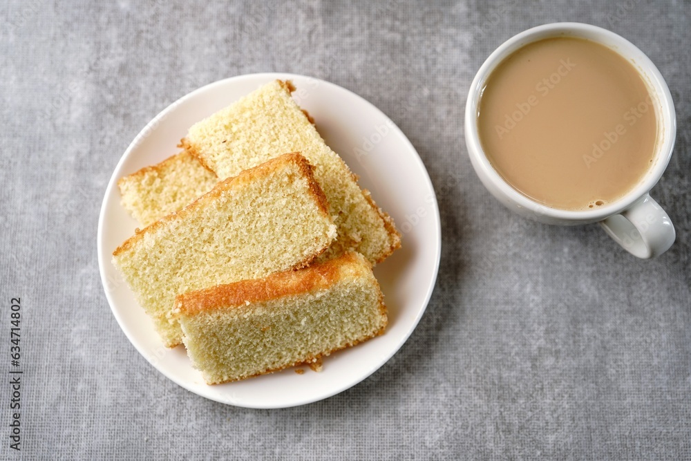 Homemade Indian butter tea cake served with cup of tea, selective focus Homemade Indian butter tea cake served with cup of tea, selective focus