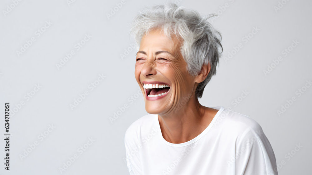 A close-up portrait of a beautiful senior woman with short gray hair, laughing and displaying her pristine teeth. This image was utilized for a dental advertisement. Gen AI A close-up portrait of a beautiful senior woman with short gray hair, laughing and displaying her pristine teeth. This image was utilized for a dental advertisement. Gen AI