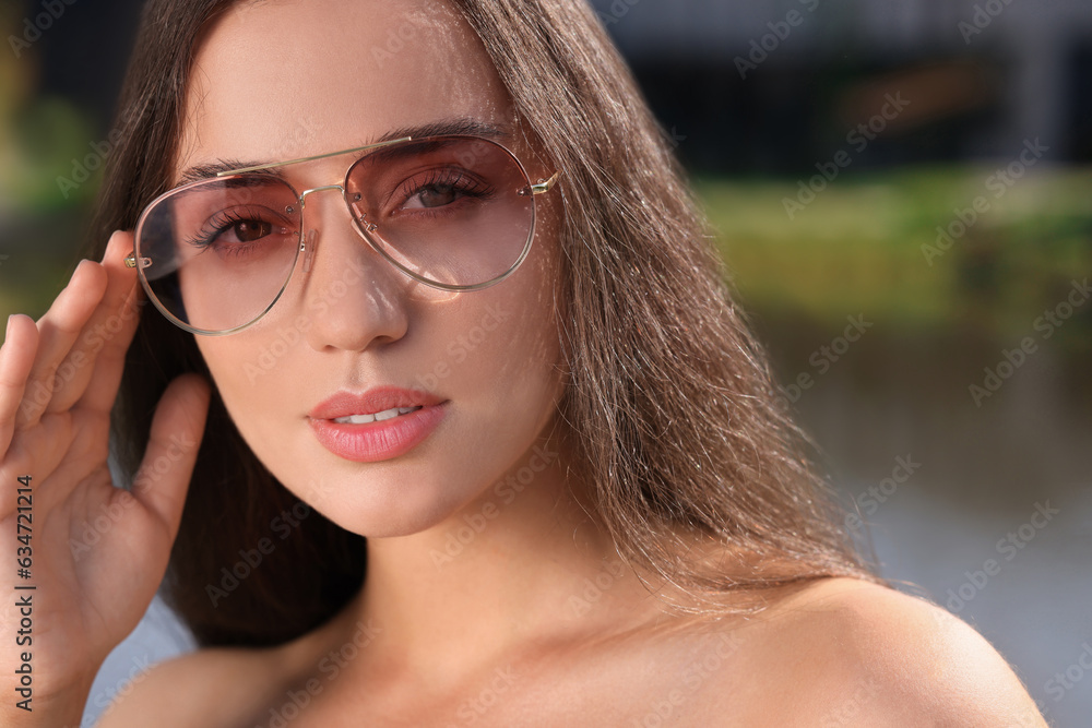 Beautiful woman in sunglasses outdoors on sunny day Beautiful woman in sunglasses outdoors on sunny day