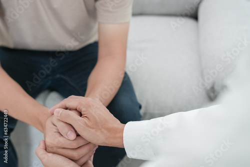 psychiatrist hold hand support each while discussing family issues. doctor encourages and empathy woman suffers depression. psychological, save divorce, Hand in hand together, trust, care.