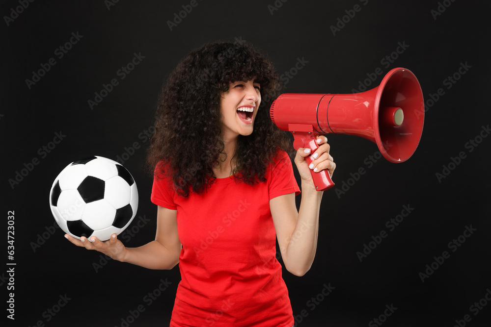 Happy fan with soccer ball using megaphone on black background Happy fan with soccer ball using megaphone on black background