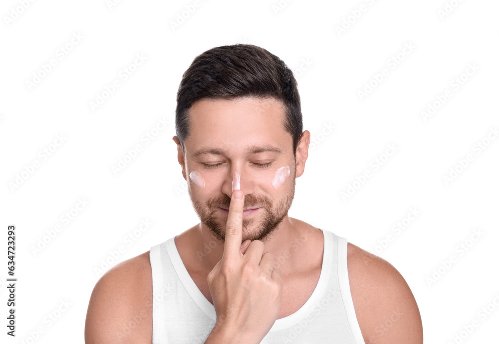 Man applying sun protection cream onto his face against white background