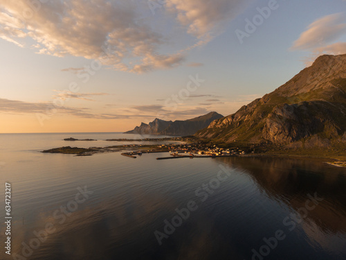 Aerial view over Ramberg, northern Lofoten, Norway. Mountains, sea, reflections, cloudscape.