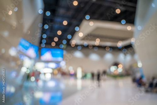 Blurred images of trade fairs in the big hall. image of people walking on a trade fair exhibition or expo where business people show innovation activity and present products in a big hall.