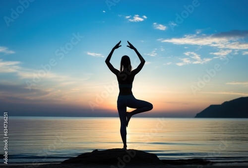 Girl in yoga pose on the beach