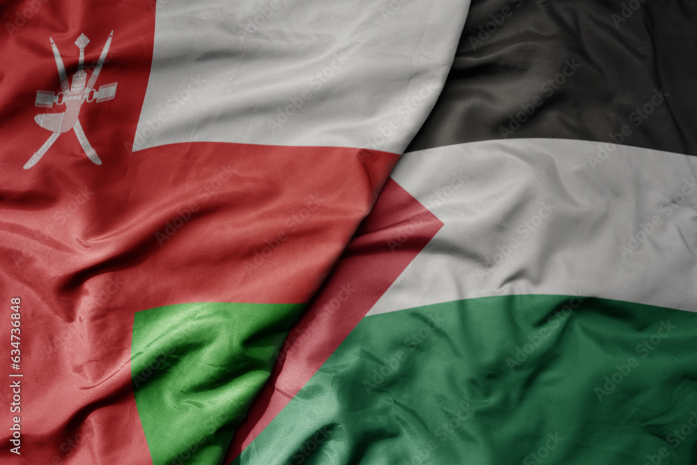 big waving realistic national colorful flag of oman and national flag of palestine .