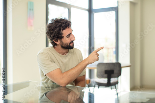 young bearded man with a copy space on a table