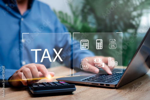 Government tax payment Individual income tax return concept, Businessman use laptop and calculator for Calculation tax payment financial statement of Business Accounting and data to tax online photo