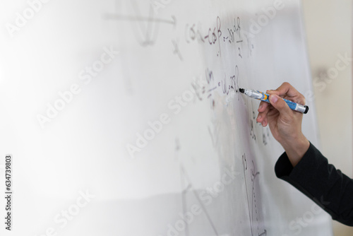 asian teacher write on white board. Woman writing on white board wall. Idea creative education teaching math and spelling letter  knowledge  back to school concept