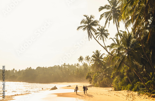 three people walking in a scenic coconut beach at sunset time.
Silent Beach, Tangalle, Sri Lanka