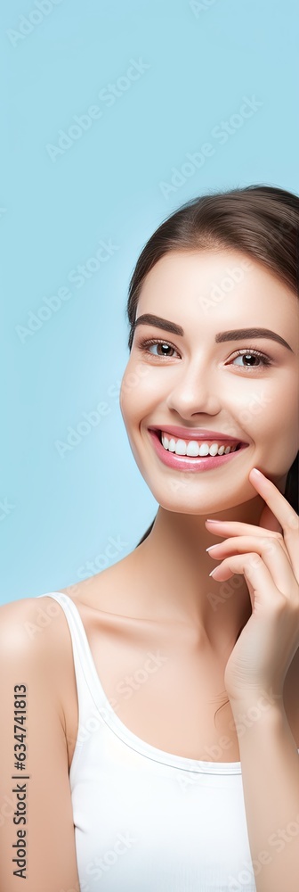 Woman demonstrates healthy and perfect teeth on blue background promoting dental treatment and oral care Woman demonstrates healthy and perfect teeth on blue background promoting dental treatment and oral care