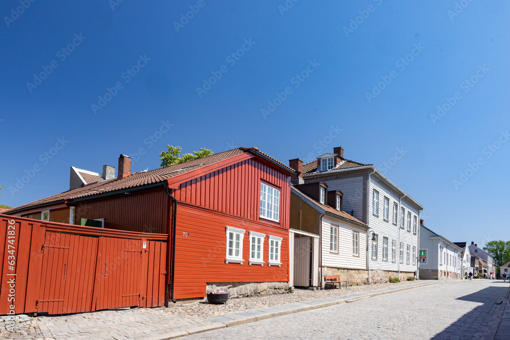 Happy walking in old Fredrikstad on a great warm summer day, with many old buildings, Norway	