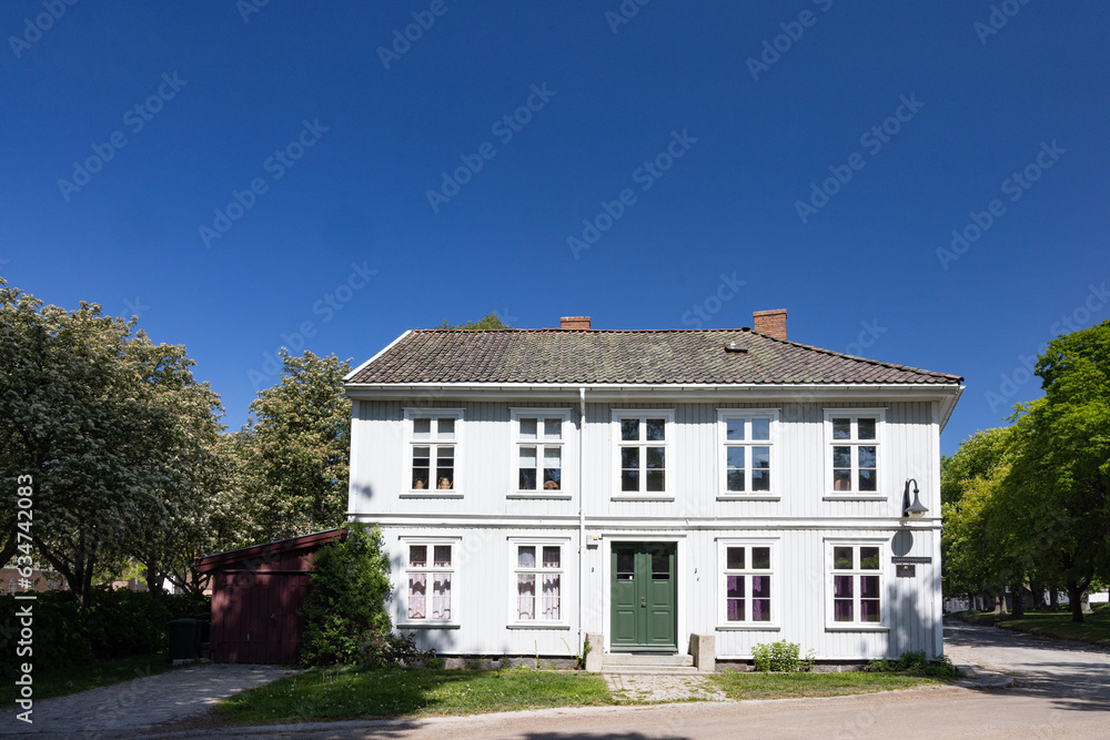 Happy walking in old Fredrikstad on a great warm summer day, with many old buildings, Norway	