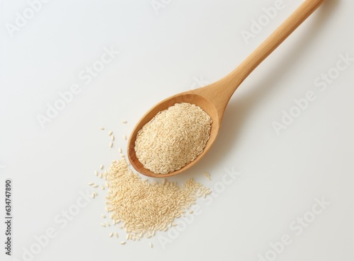 Uncooked white quinoa seeds, in the wooden bowl, isolated on pure white background, top view.